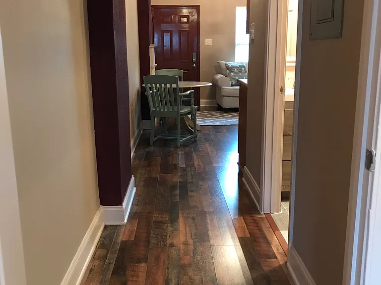 Hallway lookin at front door and bathroom door to the right