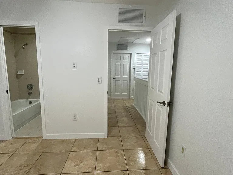 Master bedroom with bathroom and closet with light