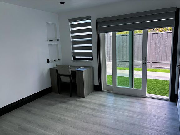 Bedroom 1 with floor-to-ceiling glass door