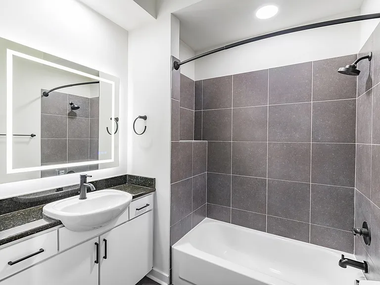 Serene bathrooms featuring LED backlit mirrors.