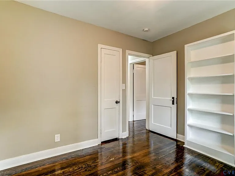 Rear facing bedroom with built in bookcases/shelving