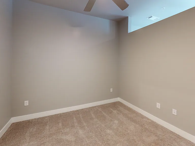 The Railyard studio apartment features a separate bedroom with a partial wall, providing privacy from the common area. The Railyard studio apartment features a separate bedroom with a partial wall, providing privacy from the common area.