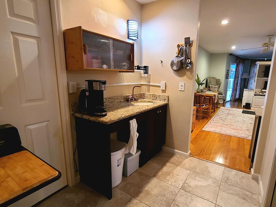 Kitchenette with small appliances, storage above and below, filtered water, microwave air fryer, electric covered skillet and more.