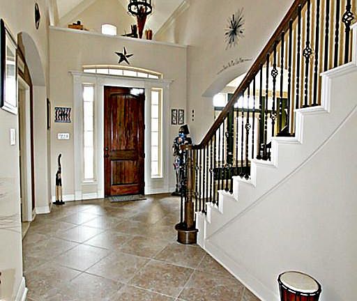 STEP INSIDE TO THE SOARING FOYER WITH AN ART NICHE AND ARCHWAYS