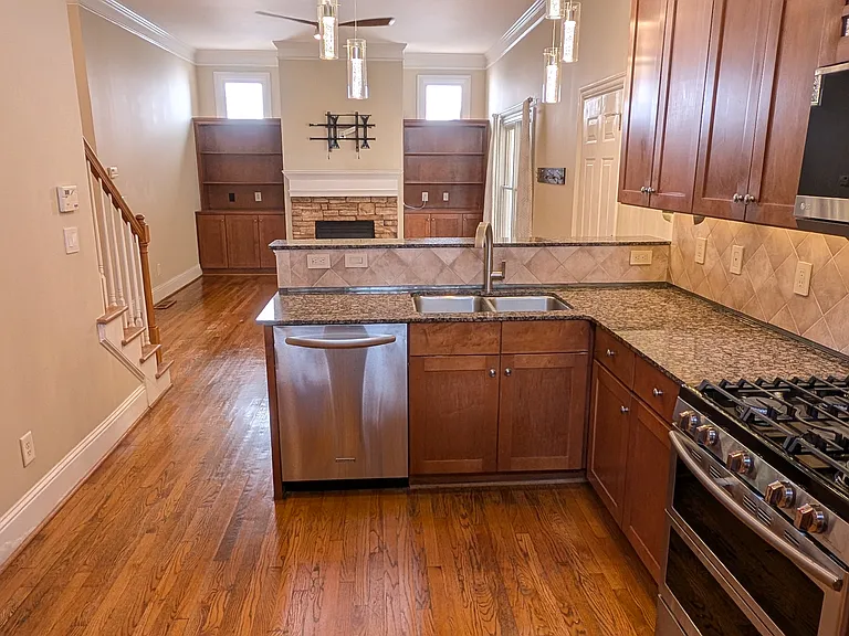 Open floor plan provides view to fireplace and flat panel from the kitchen.