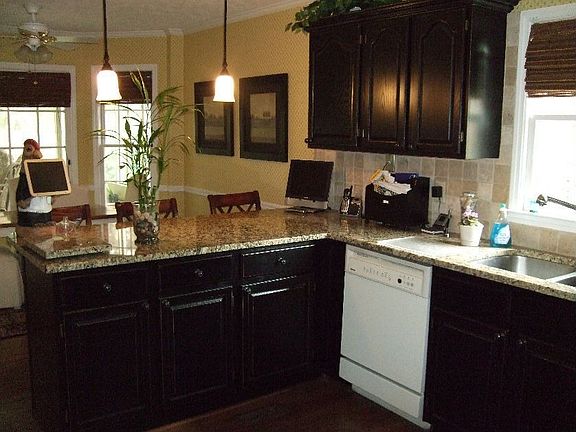 Updated kitchen with pendant lighting and granite counters.