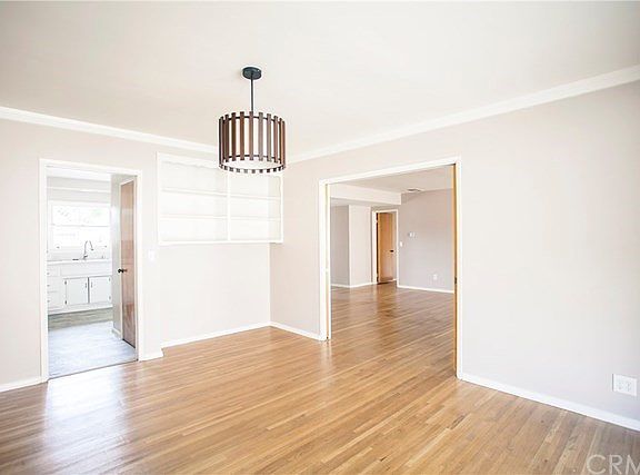 Spacious formal dining room with new light fixture and crown moulding