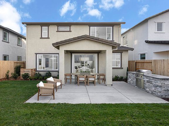 Backyard with covered patio and built-in outdoor kitchen