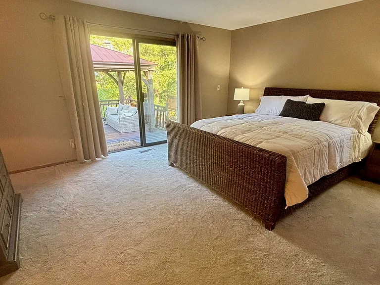 Large Primary bedroom with California King bed. 55" wall mounted TV.