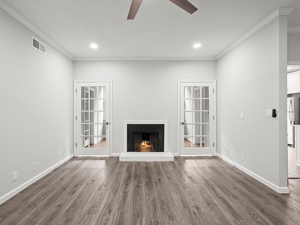 Living room with working wood fireplace. New remote controlled fan, canned lighting throughout.