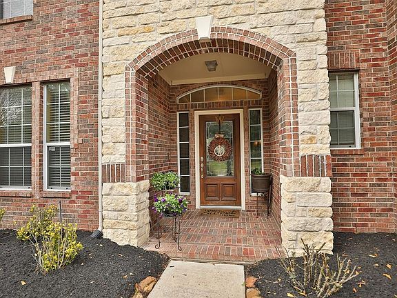 Arched brick covered front porch provides ample protection from the rain and elements. Wood and lead glass inset with sidelights and transom window.