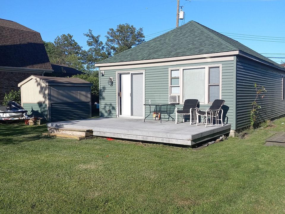 Large backyard deck along with a large backyard