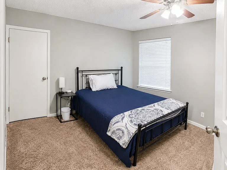 Bright bedroom with soft carpet flooring. A restful retreat after a busy day of meetings.