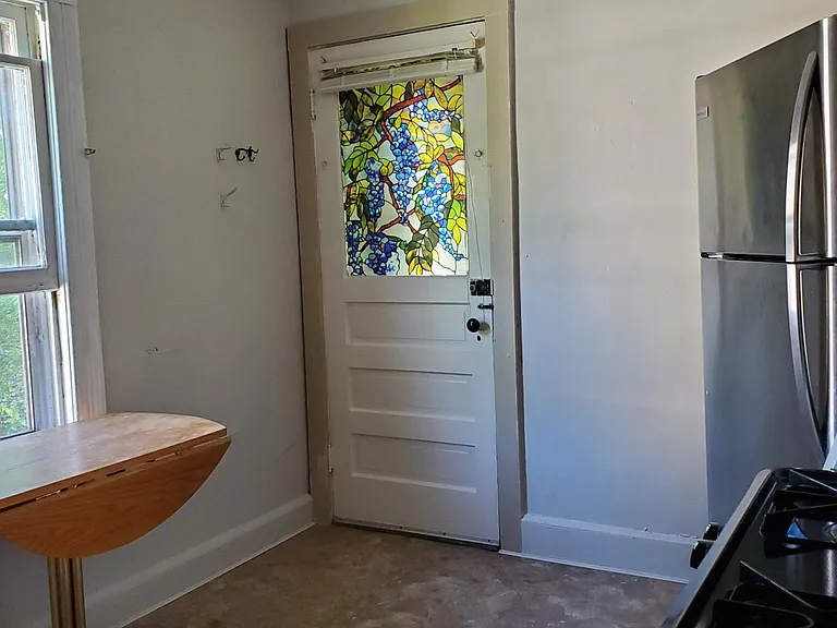 back door with stove and fridge