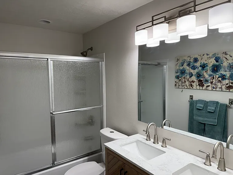 Brand, new tub, toilet, cabinet, and sinks