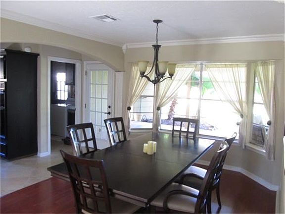 OPEN FORMAL DINING ROOM WITH VIEW OF DOUBLE LEADED GLASS DOOR ENTRY