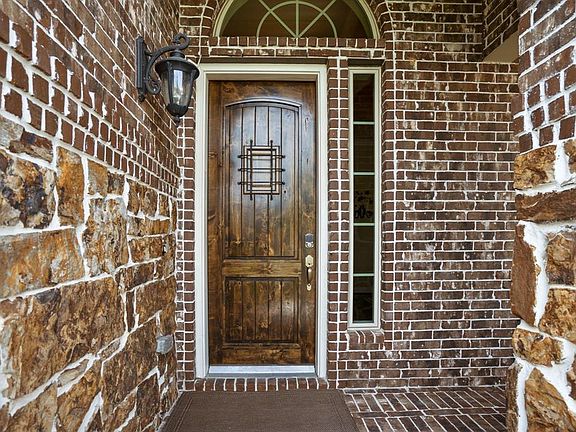 Inviting covered front porch & beautiful wood front door.