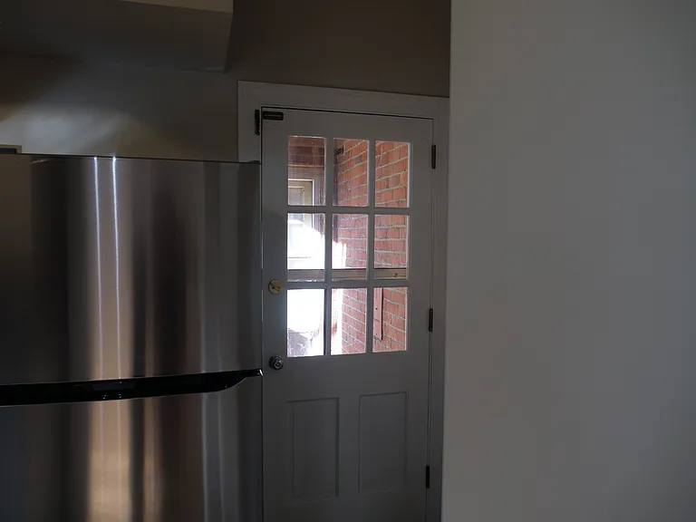 Door off kitchen leading to exterior stairwell.