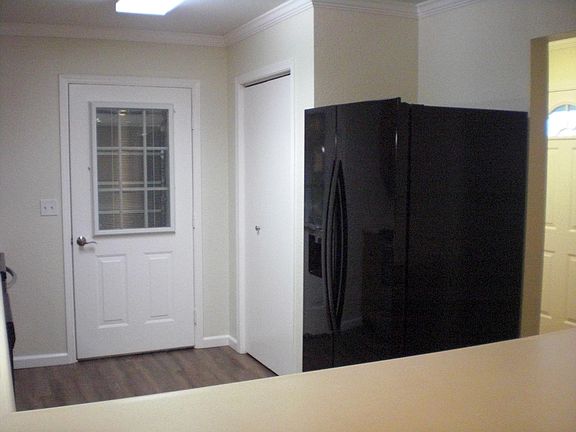 Kitchen refrigerator and door to attached garage