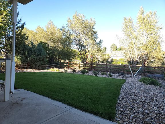 Backyard backing to walking trail leading to open space with panoramic mountain views
