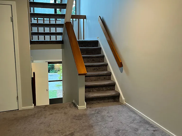 Stairs to 2nd floor with large hallway windows