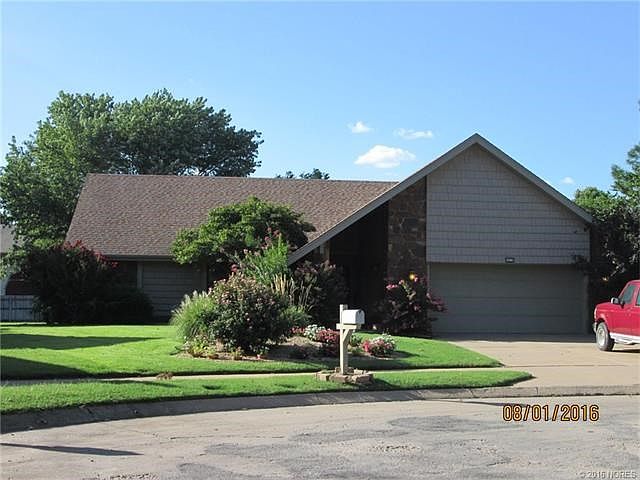 Street View. Beautiful landscaping. Sprinkled lawn.