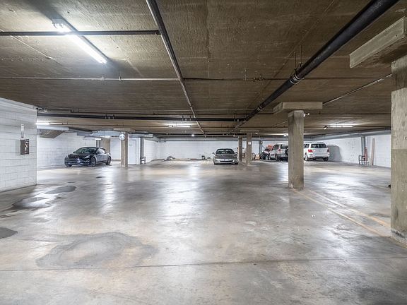 Secure, gated, indoor parking garage with automatic garage doors.