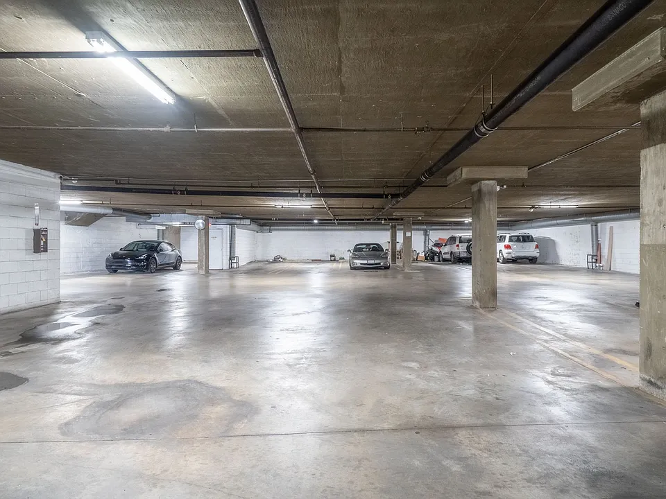 Secure, gated, indoor parking garage with automatic garage doors.