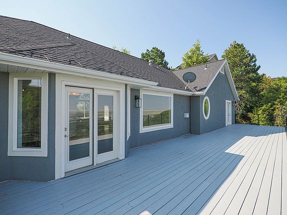 Large deck with plenty of space for outdoor dining, grilling and relaxing with a refreshing beverage. Access to living room and from primary bedroom.