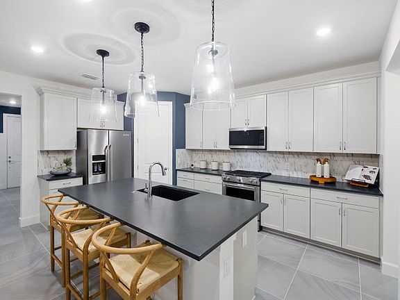 Open kitchen with center island and walk-in pantry