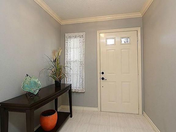 Another view of the entry way features tile flooring and a side window that adds additional natural 