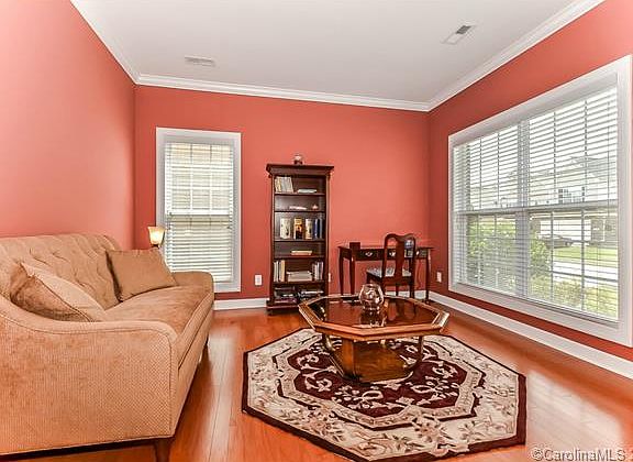 Formal living room with hardwood floors.