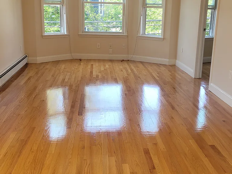 Enormous living and dining space with gleaming hardwood floors
