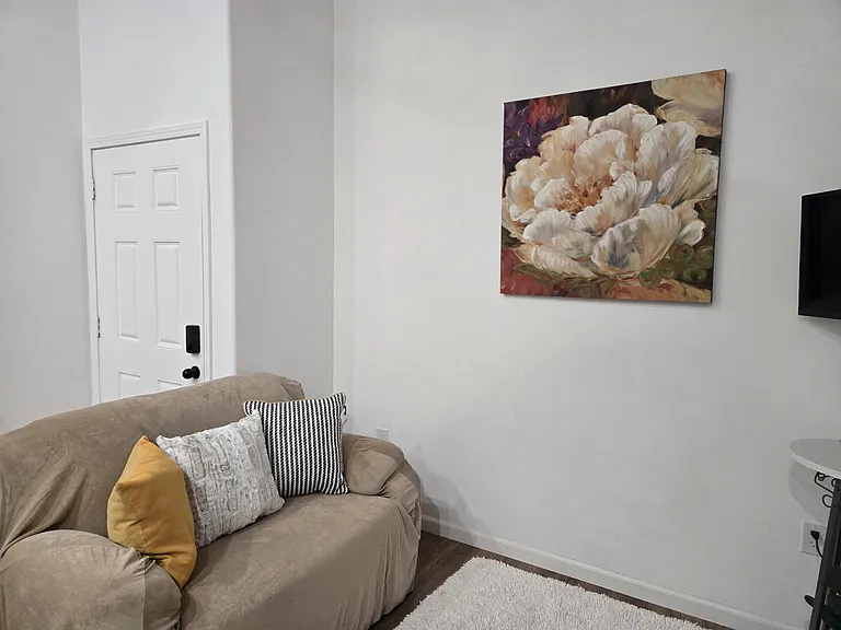 living area, includes: love seat, chair, and TV.