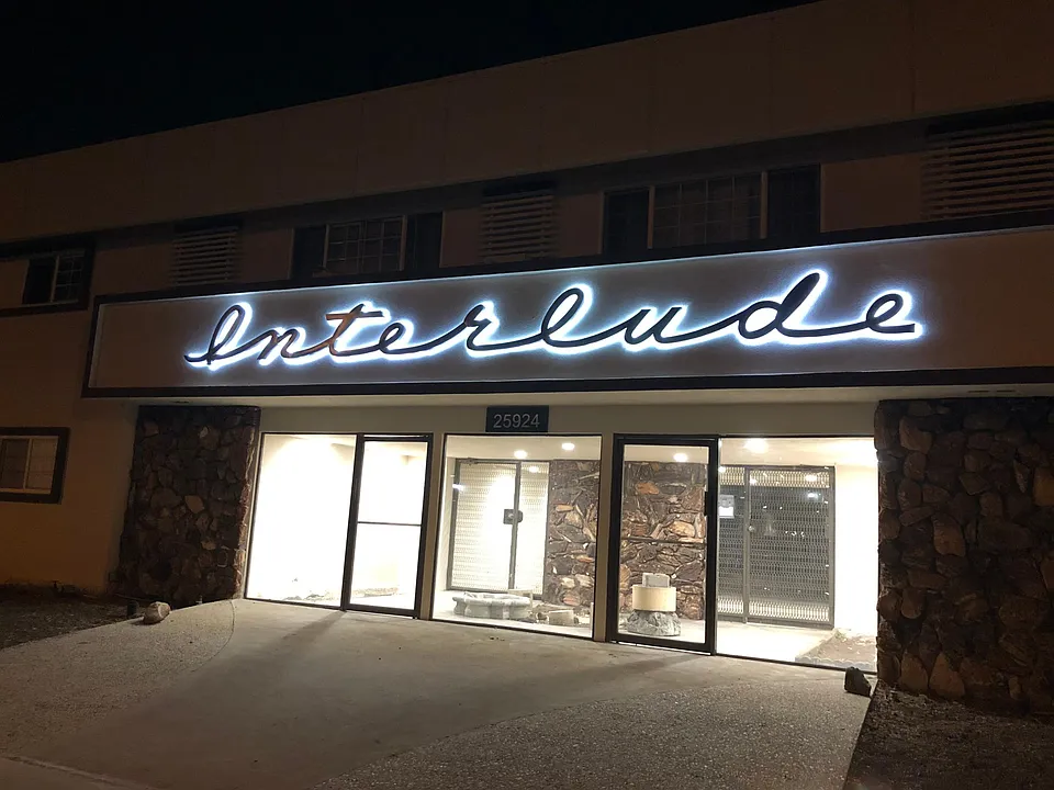 Vintage sign lights the entry.