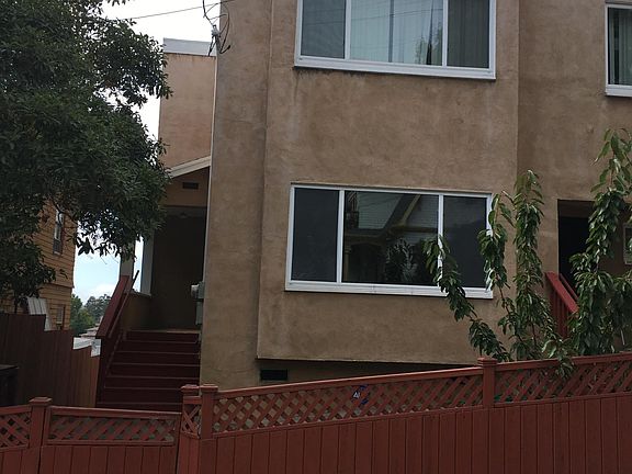 Street View of front yard with gate for entry. Studio is located in the rear.