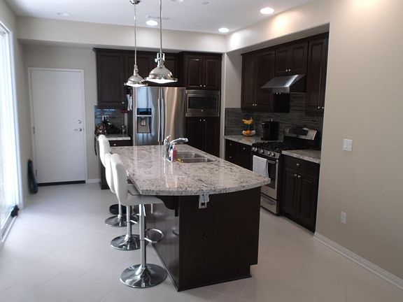 Kitchen view with slider to patio on left and door to garage straight ahead. Refrigerator top of the line.