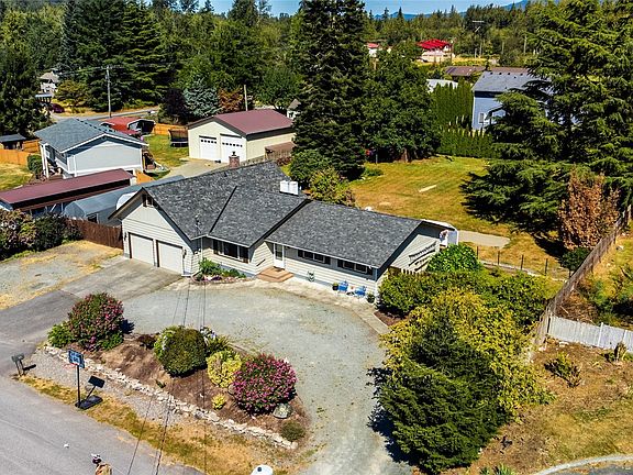 Circular driveway and RV parking to the left.>
