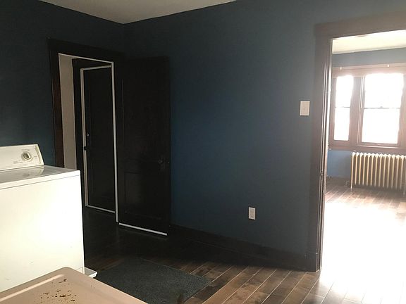 Laundry room entrance from stairs and doorway to sunroom