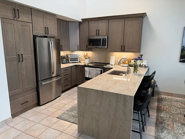 New kitchen cabinets, countertops, and GE appliances.