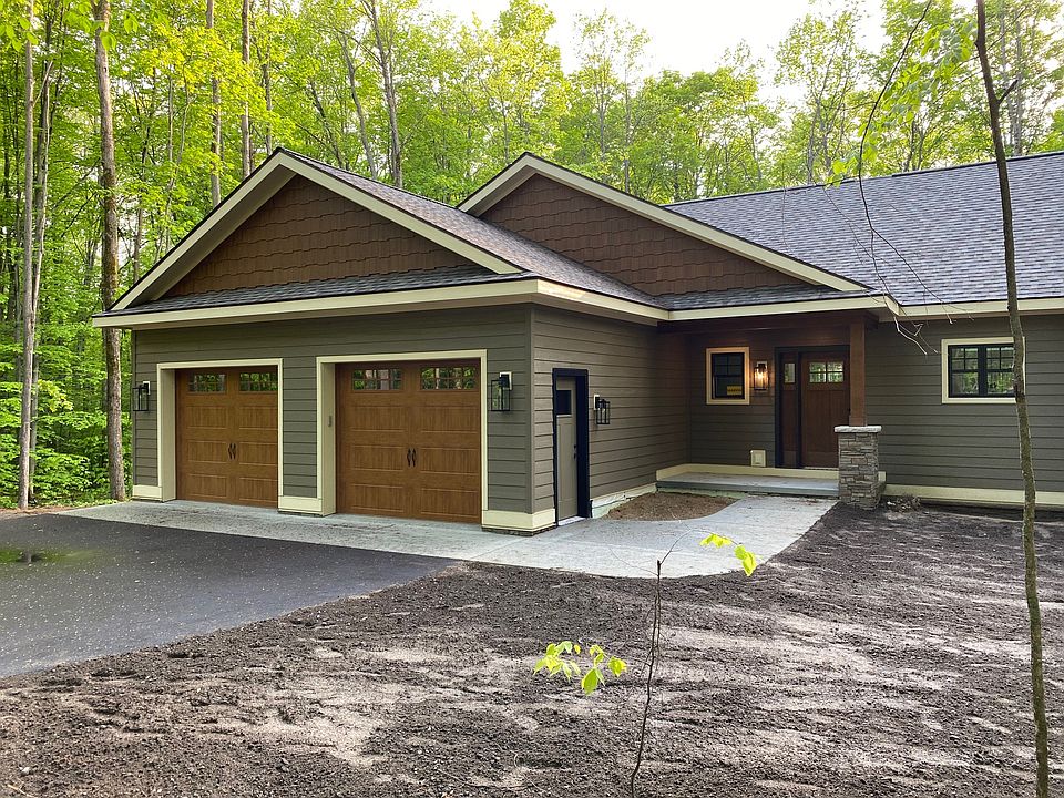 Insulated, stained fiberglass garage doors.   Stained, insulated fiberglass entry door and side lite.