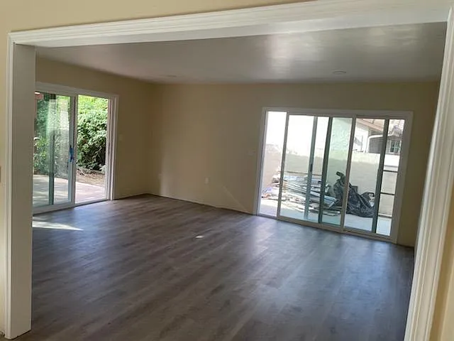 Large Living Room with New Sliding Glass Doors, 100% Waterproof Laminate Flooring Throughout