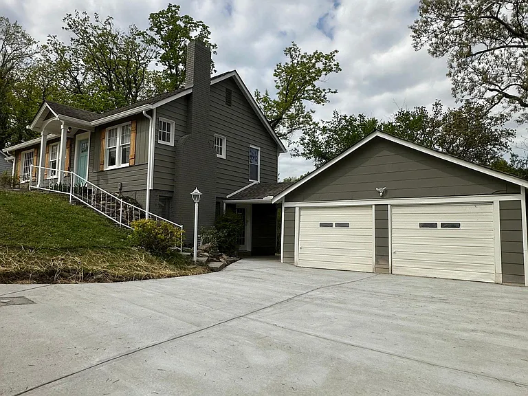 Exterior w/ garage and parking pad