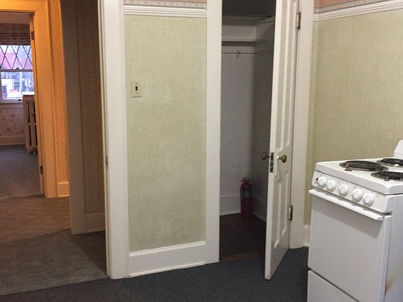 In kitchen looking toward pantry, entry hall and into living room