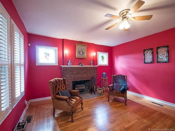 Living Room with Fireplace and Plantation Shutters