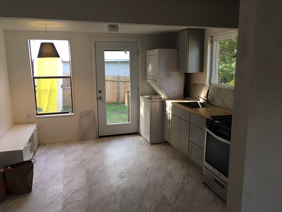 kitchen with laundry, backdoor to fenced yard and porch