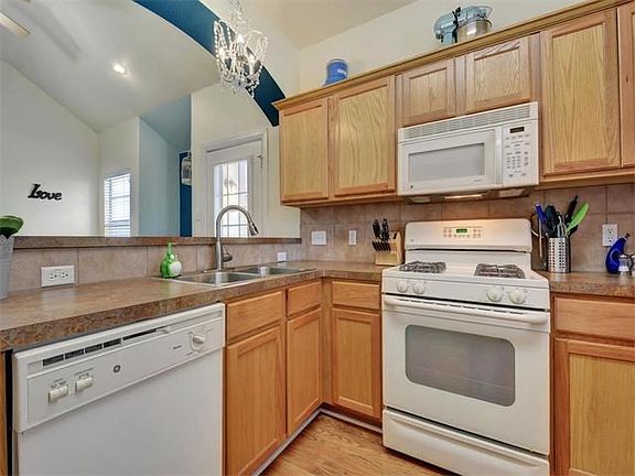 Kitchen has a breakfast bar that is open to the living room.