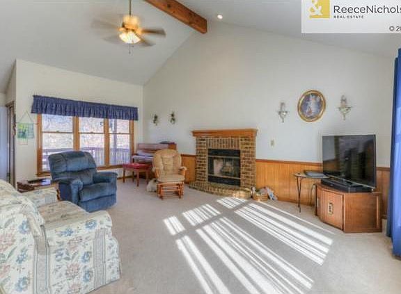 Vaulted Great room is flooded with lots of light, neutral colors