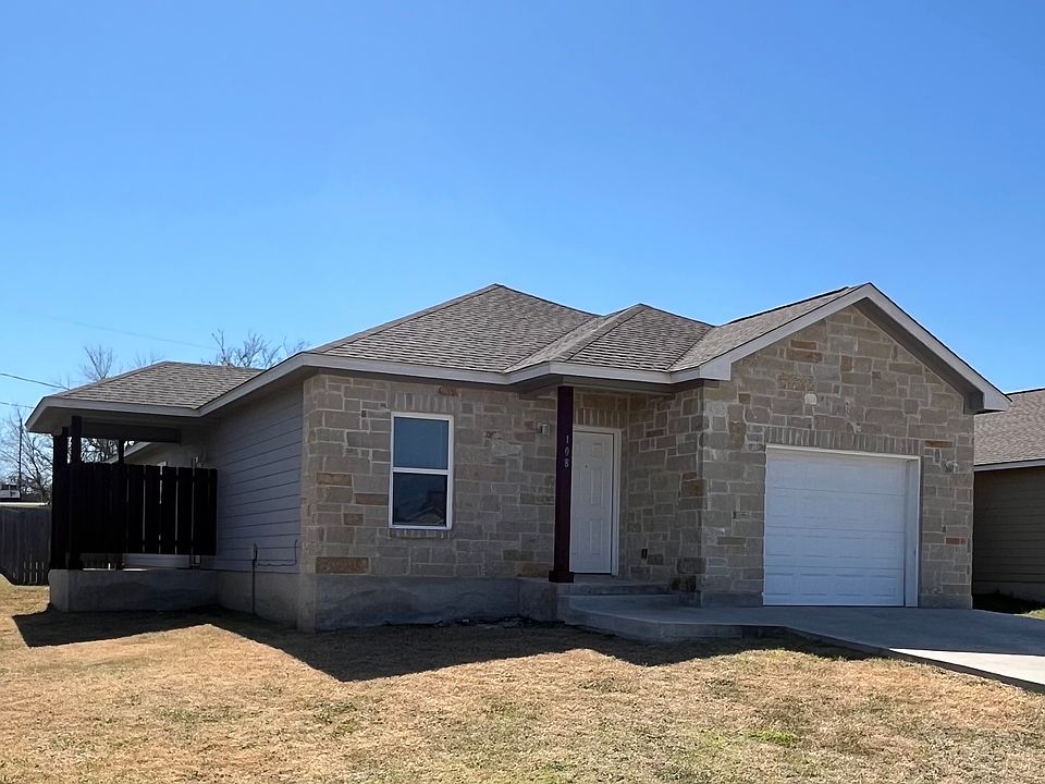 Beautiful Sandstone front with private side porch, 1 car garage for parking or storage and spacious fenced back yard.
