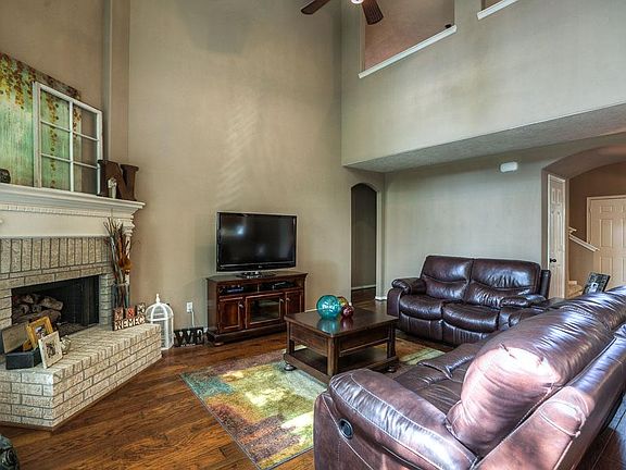 Living room has a raised hearth fireplace and gorgeous hardwood floors!